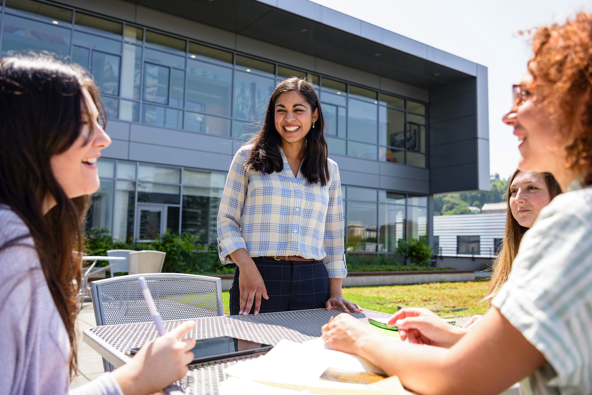 Students sitting around a table on rooftop on PSU's campus