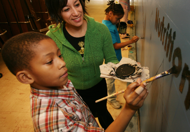 Person working with young students.